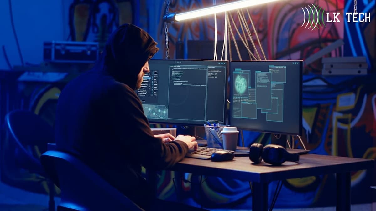 A man in black hoddie typing on keyboard